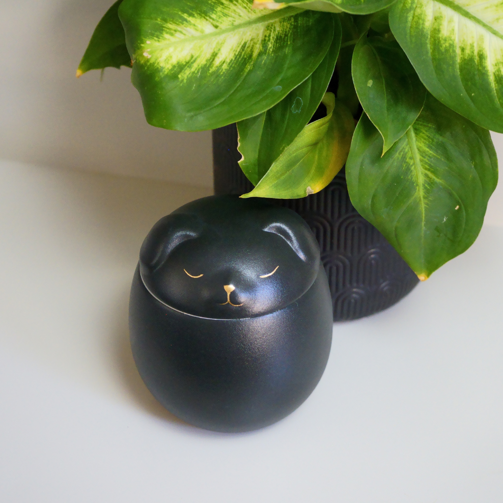 Black canine companion ceramic urn in natural setting