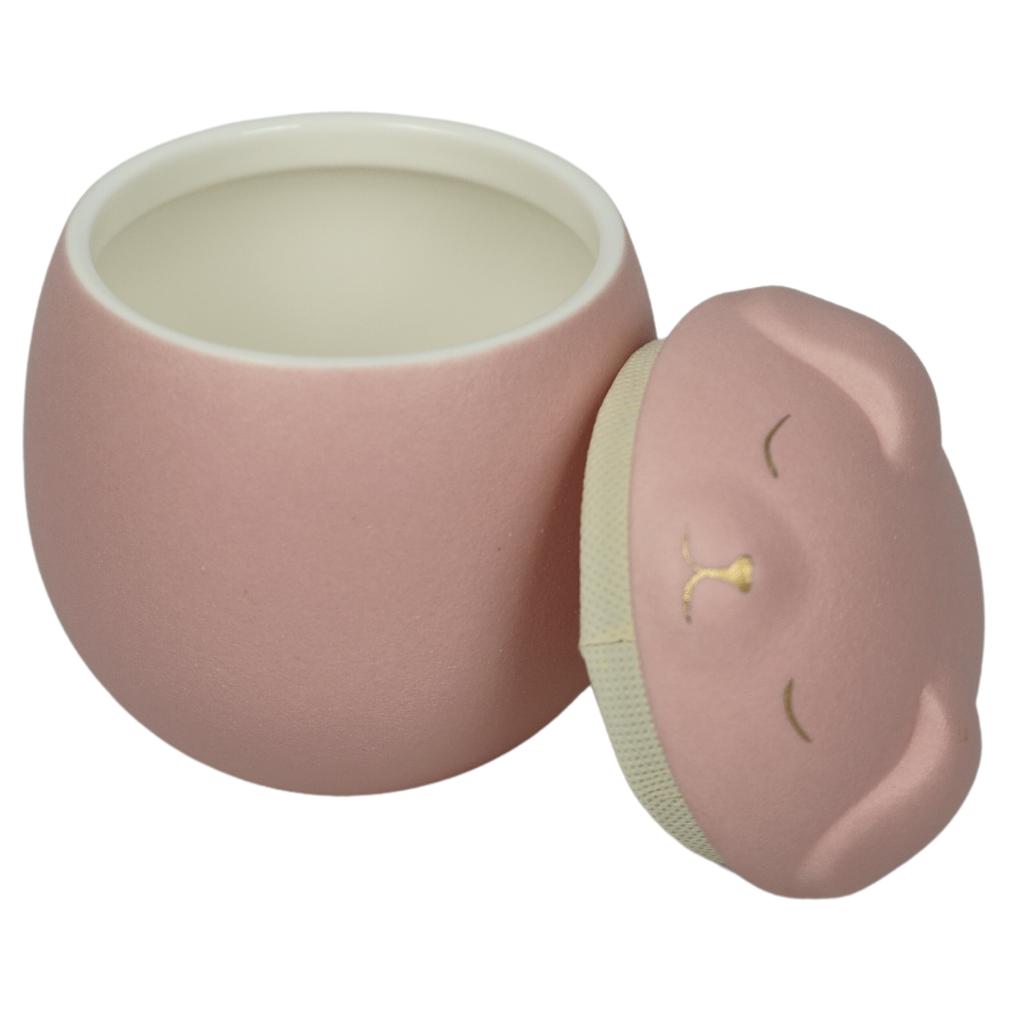 Pink canine companion ceramic urn lid off