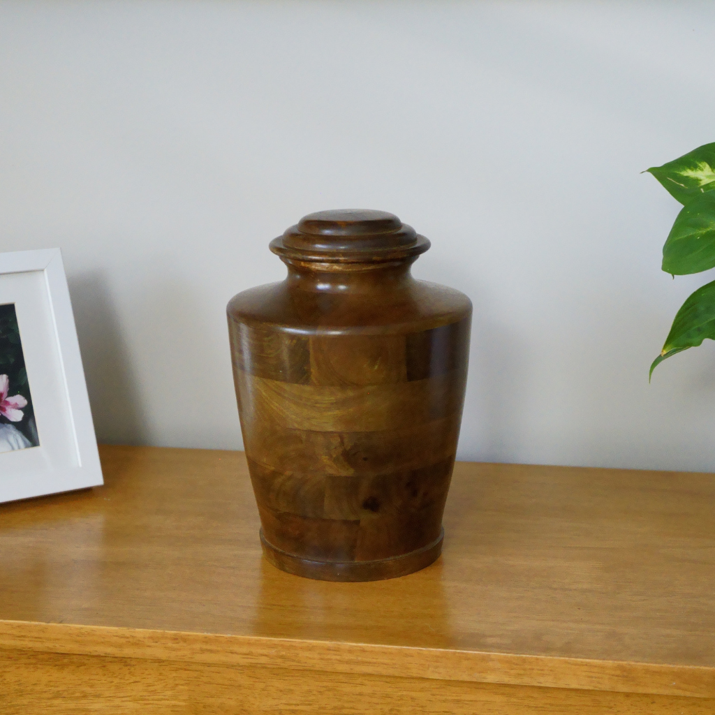 Wooden urn in traditional style in natural setting