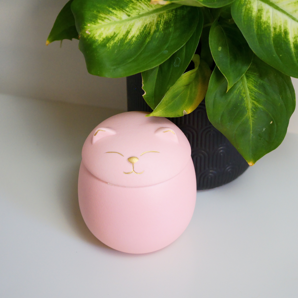 Pink kitty comfort ceramic urn in natural setting