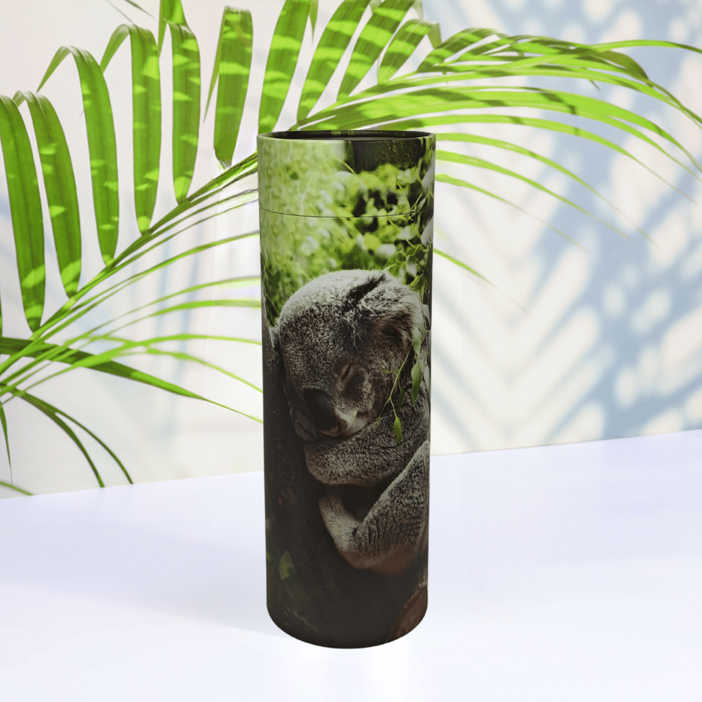Scattering Tube with a koala design on a white surface with green leaves in the background