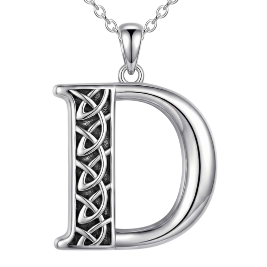 A sterling silver initial pendant necklace featuring the letter 'D' with an intricate Celtic knot design on the left side, suspended from a matching silver chain against a plain white background.