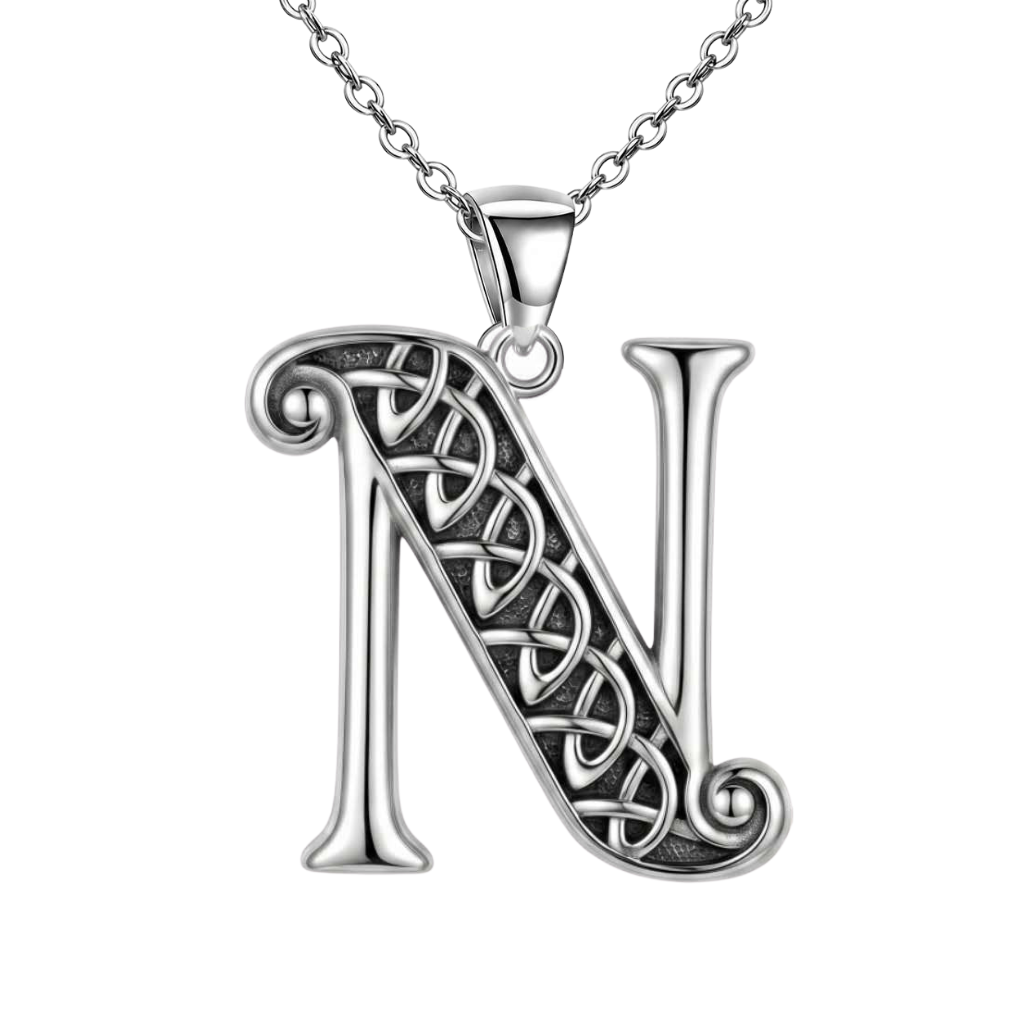 A sterling silver initial pendant necklace featuring the letter 'N' with an intricate Celtic knot design on its diagonal stem, suspended from a matching silver chain against a plain white background.