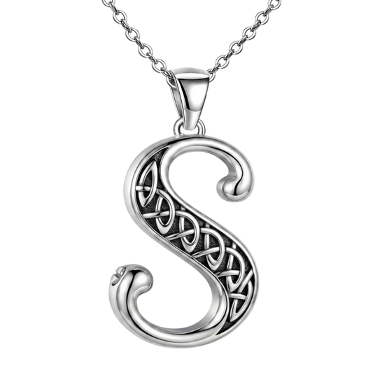 A sterling silver Celtic letter 'S' pendant necklace with an intricate knotwork design, suspended from a matching silver chain against a plain white background.