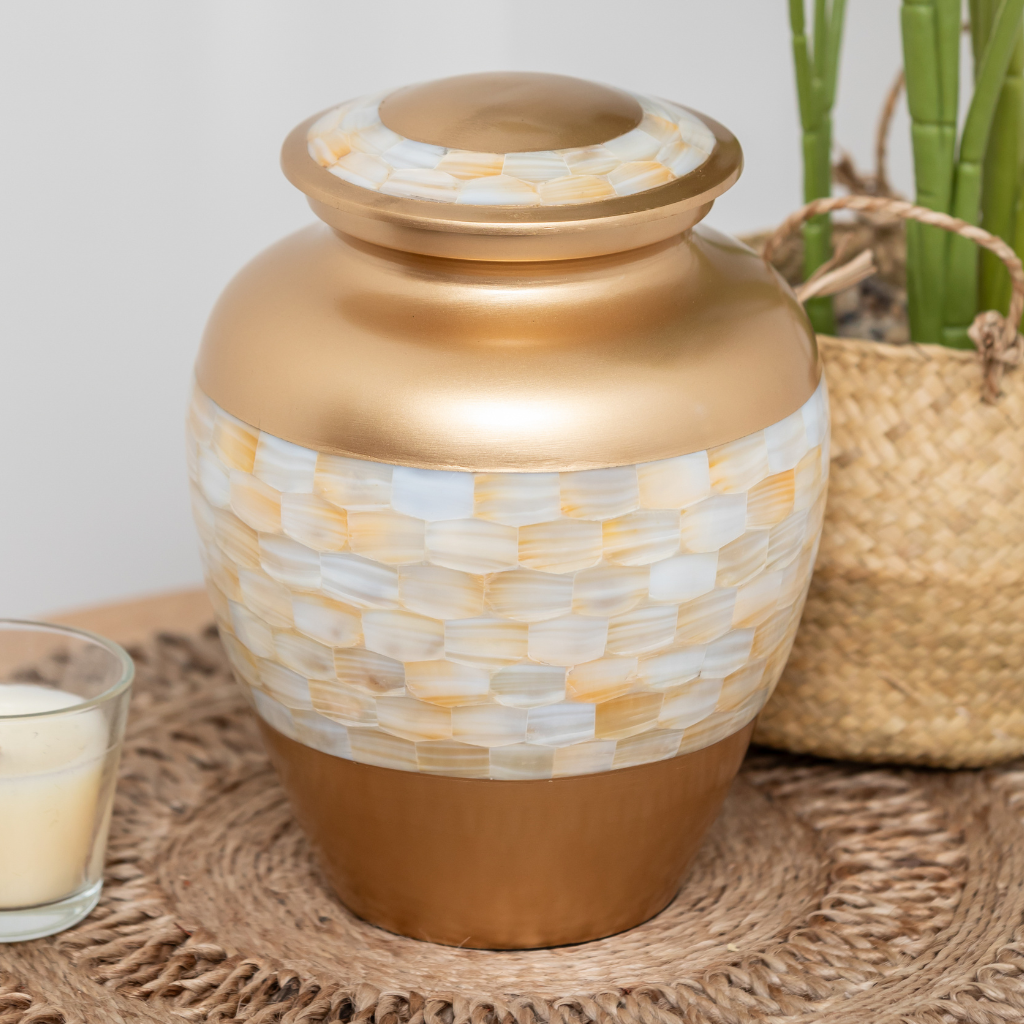 Gold urn with mother of pearl mosaic in natural setting