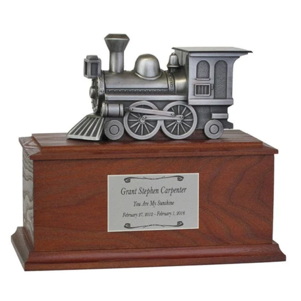Silver locomotive on top of wooden box urn